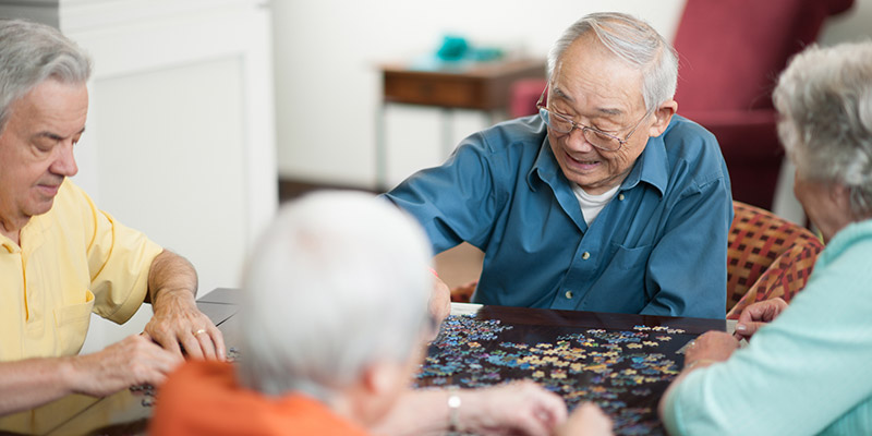 elderly men doing a puzzle